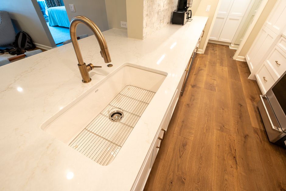 Modern kitchen with a marble countertop and sleek fixtures.